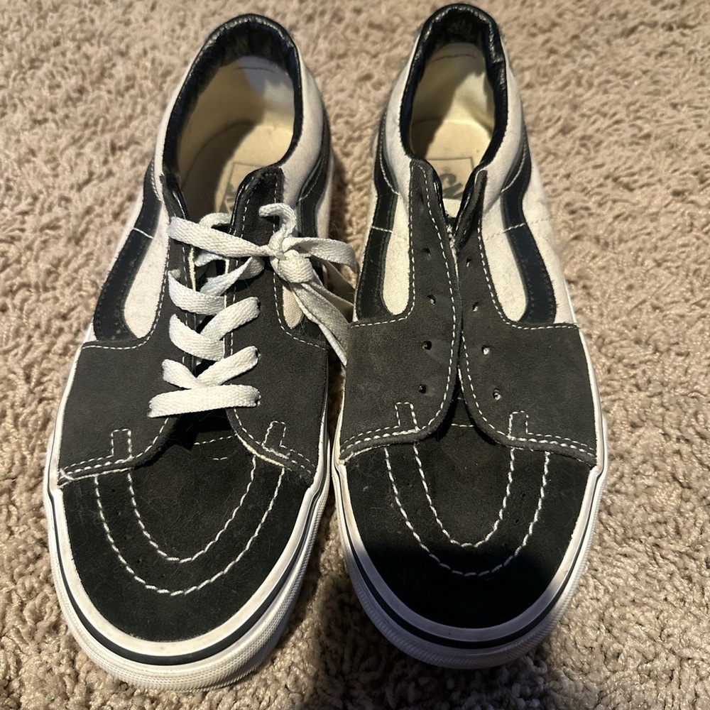 Black, white, and grey lowtop Vans